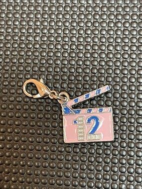 Cheaper by the Dozen pink and blue enamel charm on silver-tone back